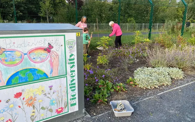 Members of the gardening club caring for the pollinator beds
