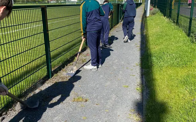 Students clearing the pitch-side walkway